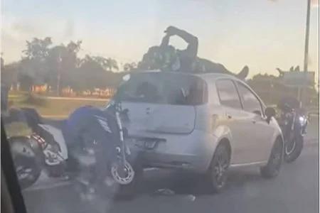 Motociclista bate na traseira de carro e para em cima do veículo